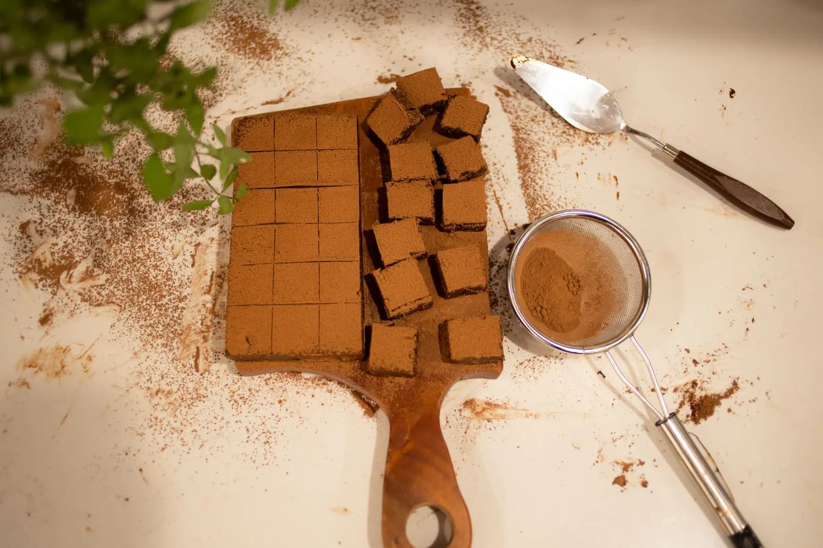 Freshly cut brownies dusted with cocoa powder on a table
