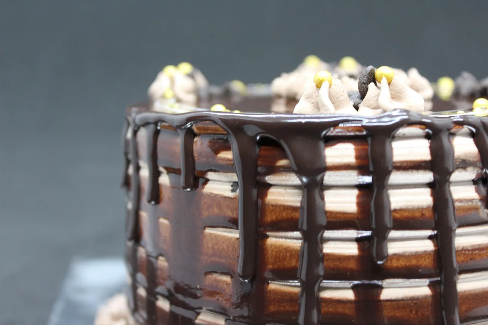 A cake with a chocolate ganache drip finish down the sides